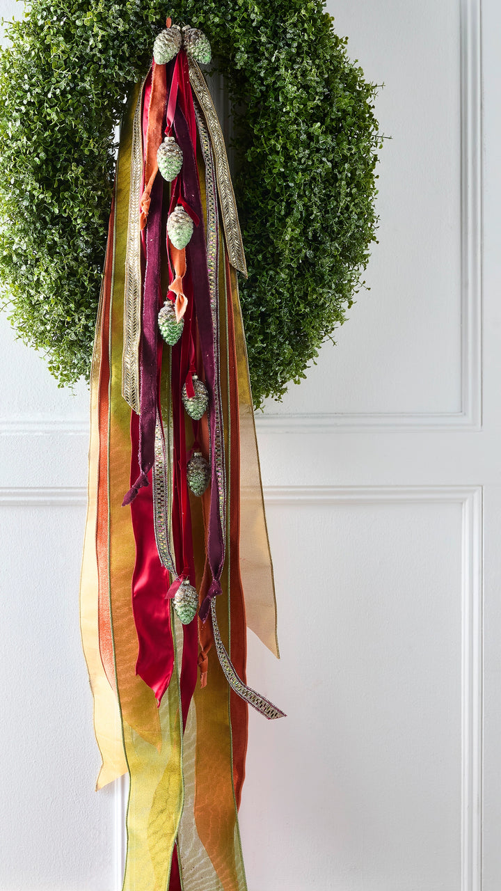 Multicolored decorative wired ribbon featuring vibrant colors and sparkling accents, beautifully displayed on a wreath. Perfect for adding shimmer and festive color to Christmas wreaths, holiday décor, celebrations, gift wrapping, garlands, bows, and special event decorations.
