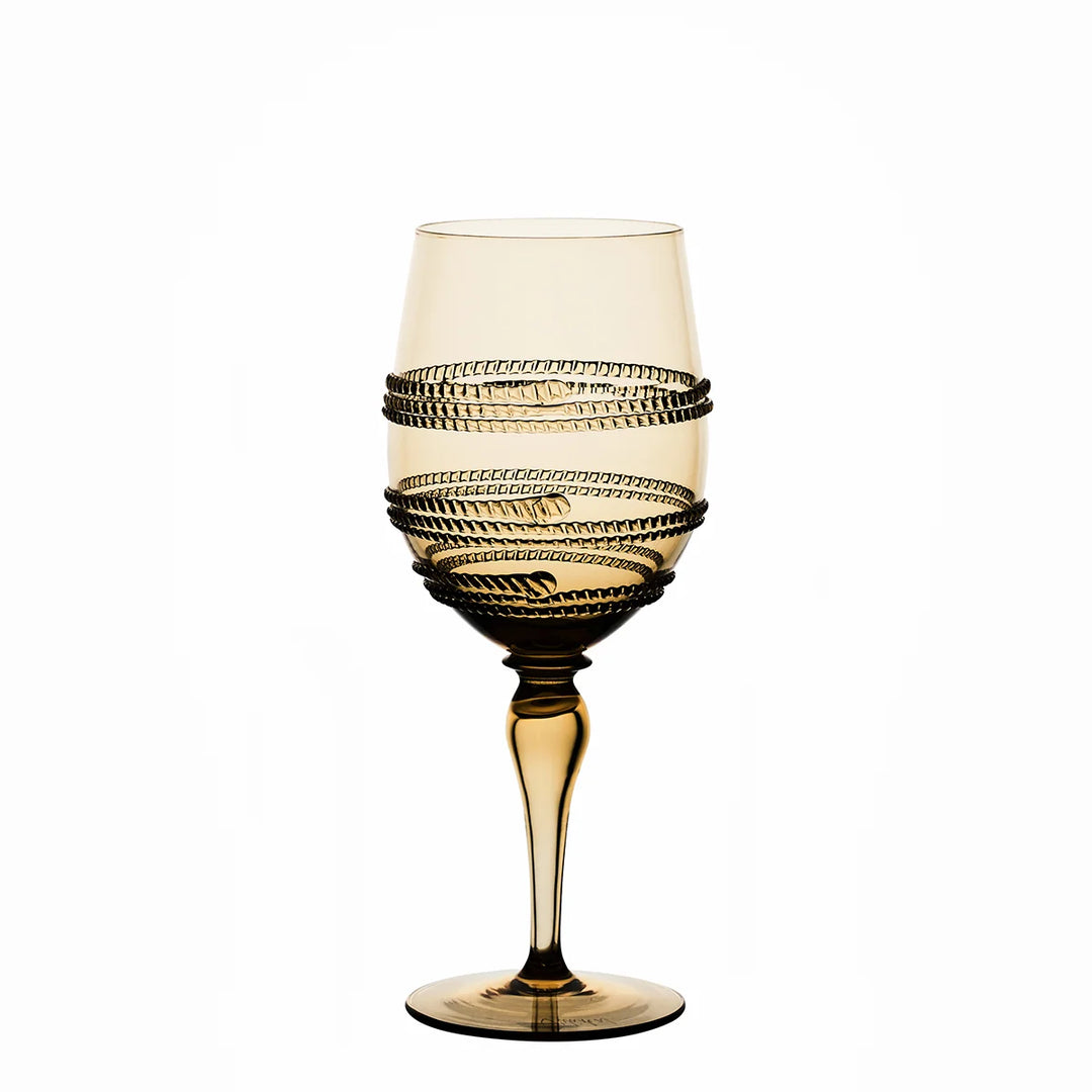 Amber gold stemmed wine glass with decorative raised textured bands wrapped around the bowl