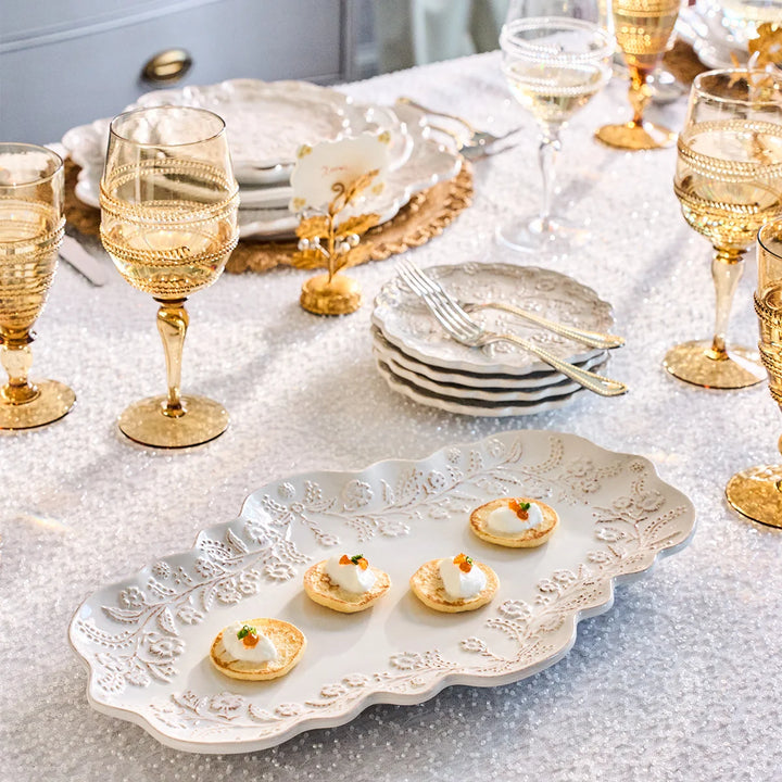 Amber gold textured wine glass styled on an elegant white and gold entertaining tablescape