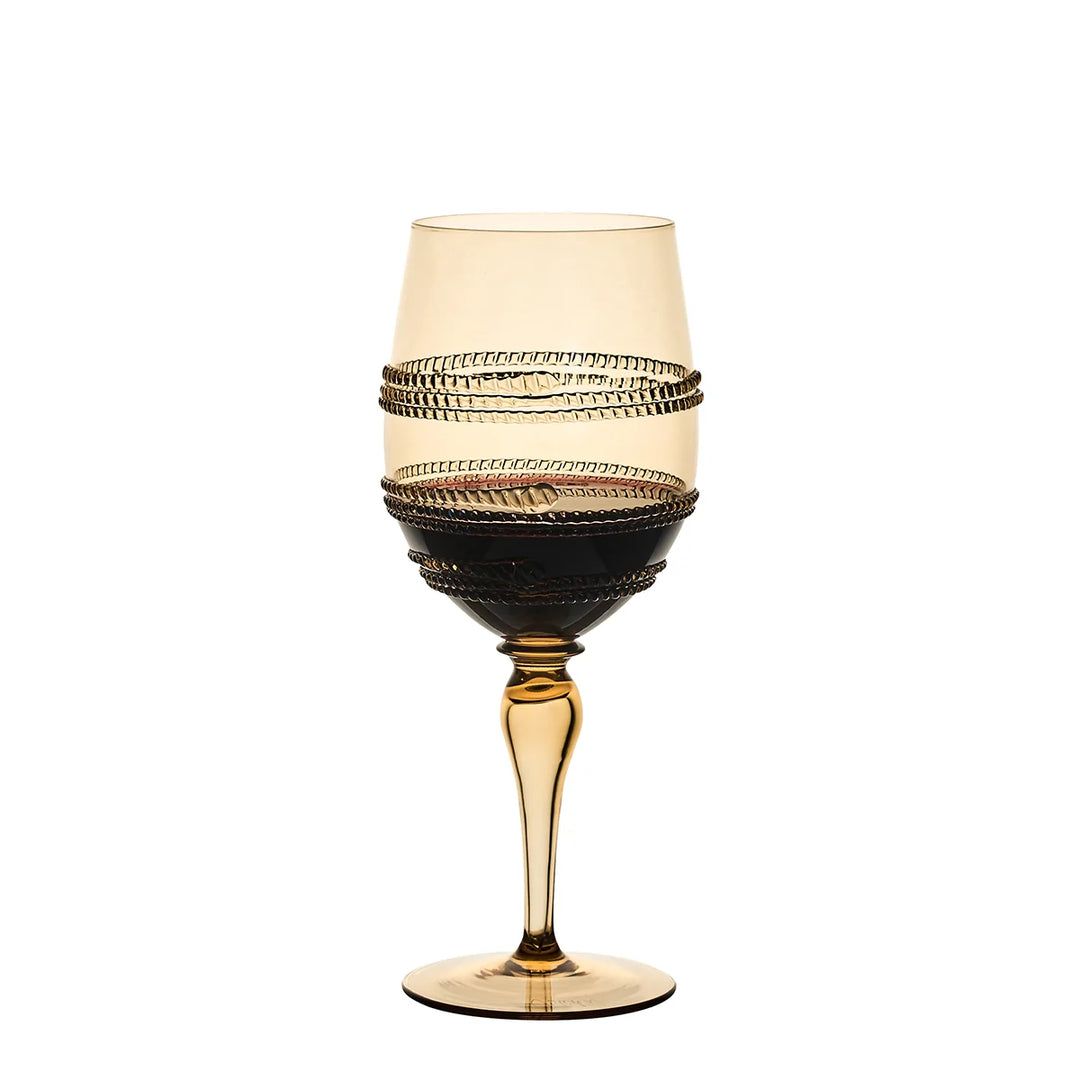 Amber gold stemmed wine glass with textured wrap detailing filled with red wine