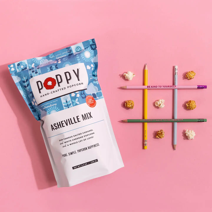 Poppy Asheville Mix Hand-Crafted Popcorn on a pink background with salted caramel and white cheddar popcorn
