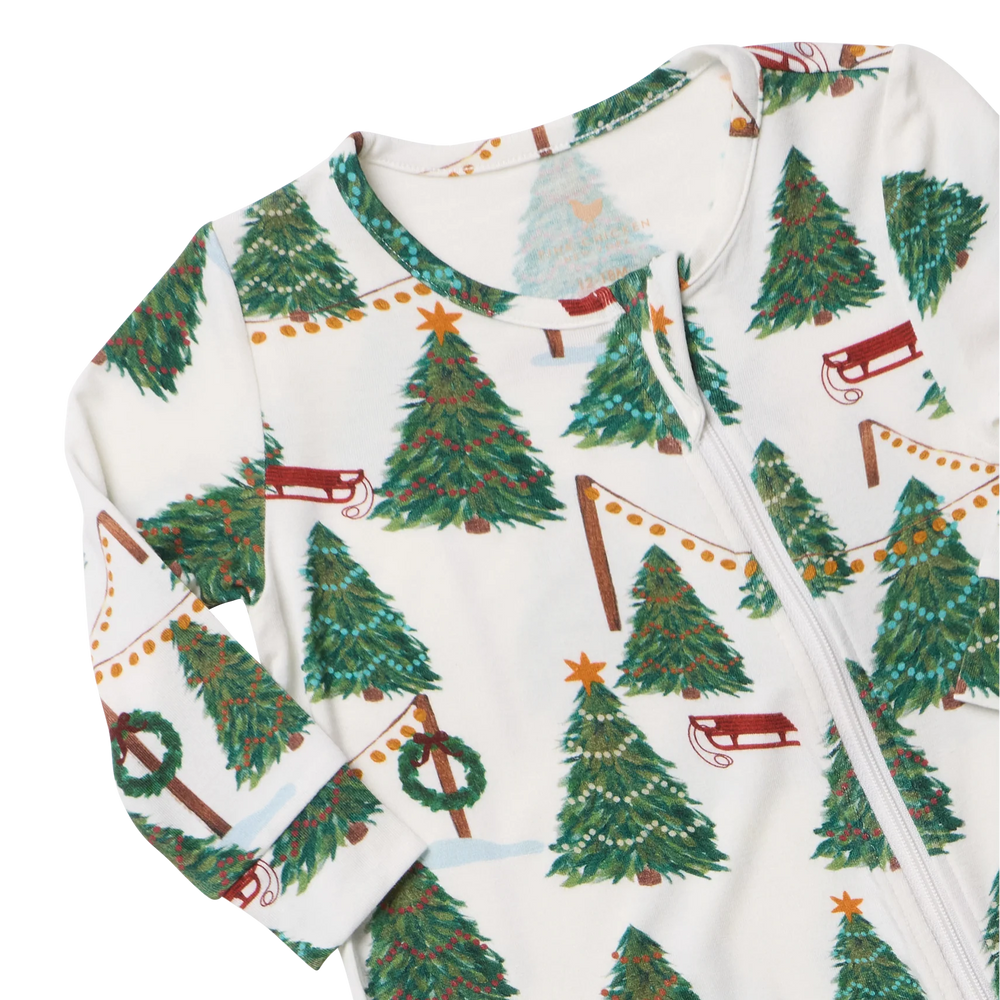 Close-up of Baby Bamboo Christmas Romper featuring soft bamboo fabric, a front zipper, Christmas trees, and festive garlands.