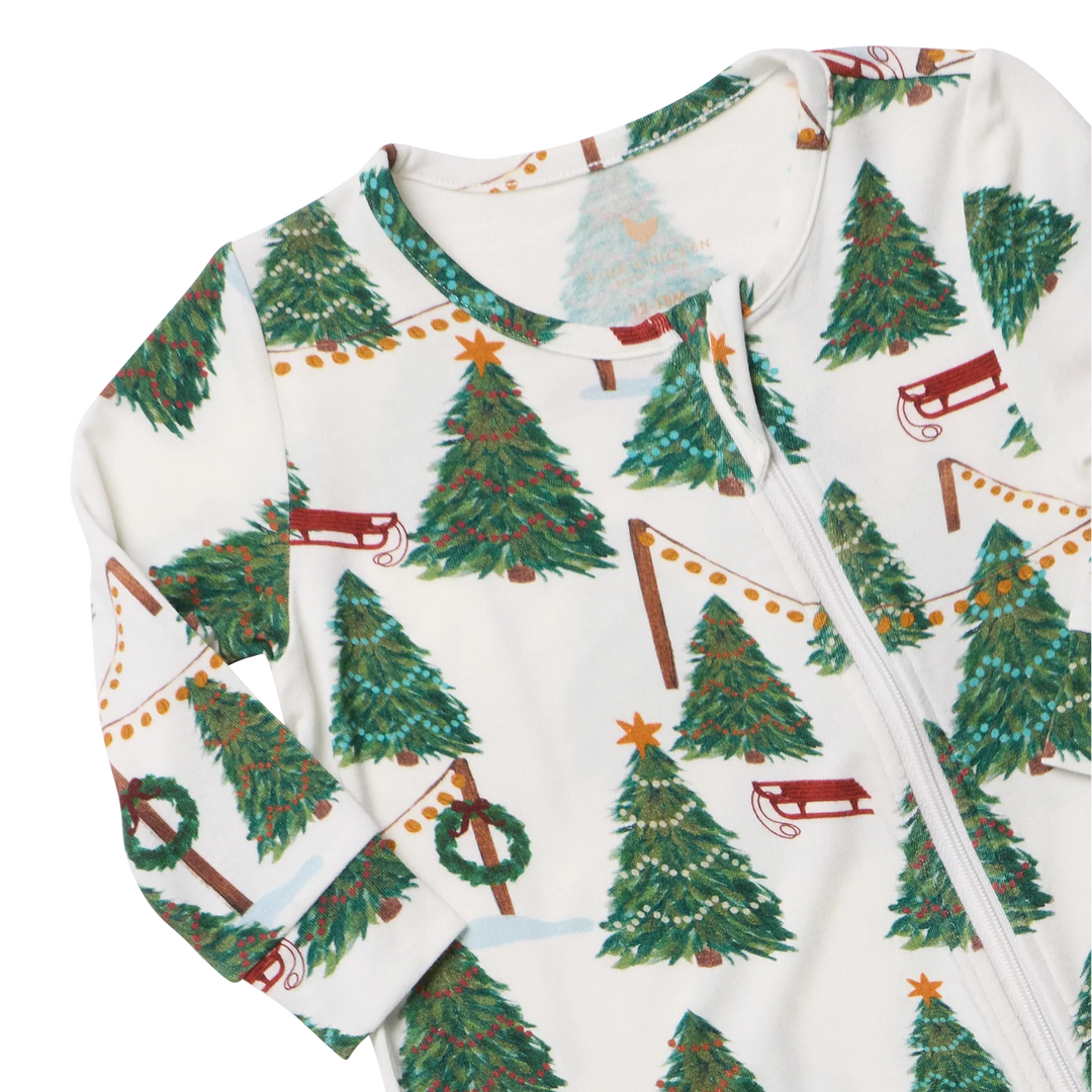 Close-up of Baby Bamboo Christmas Romper featuring soft bamboo fabric, a front zipper, Christmas trees, and festive garlands.