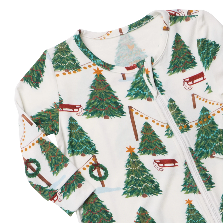 Close-up of Baby Bamboo Christmas Romper featuring soft bamboo fabric, a front zipper, Christmas trees, and festive garlands.