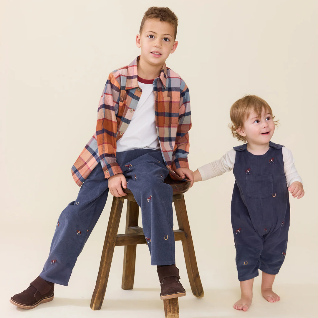 Baby boy wearing a navy horse embroidered jumper styled with coordinating boys fall clothing