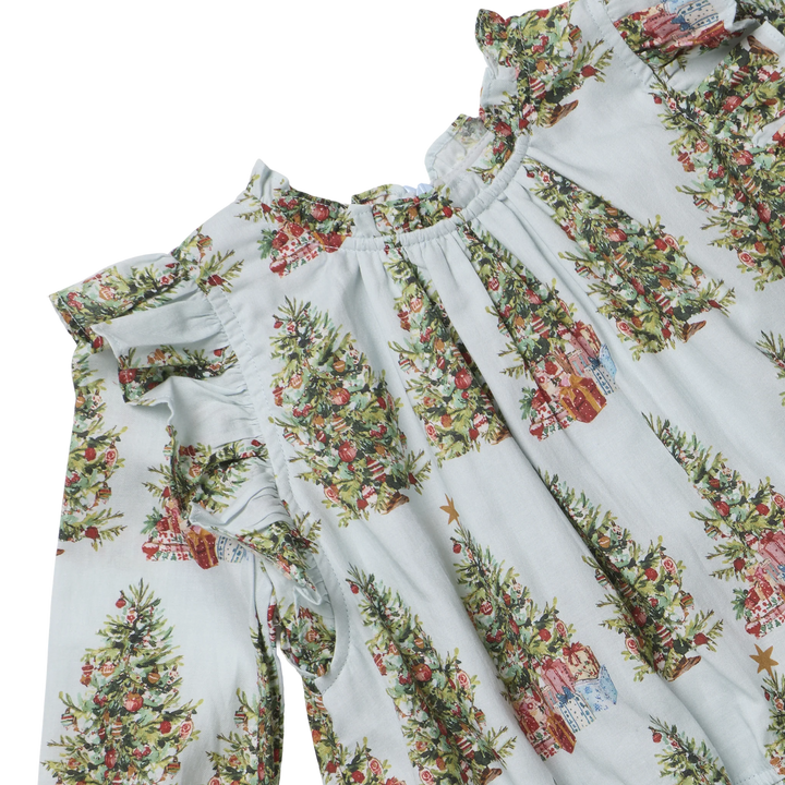 Close-up of the Baby Girls Harper Dress Set showing ruffled shoulders, gathered neckline, and colorful Christmas tree and presents print.