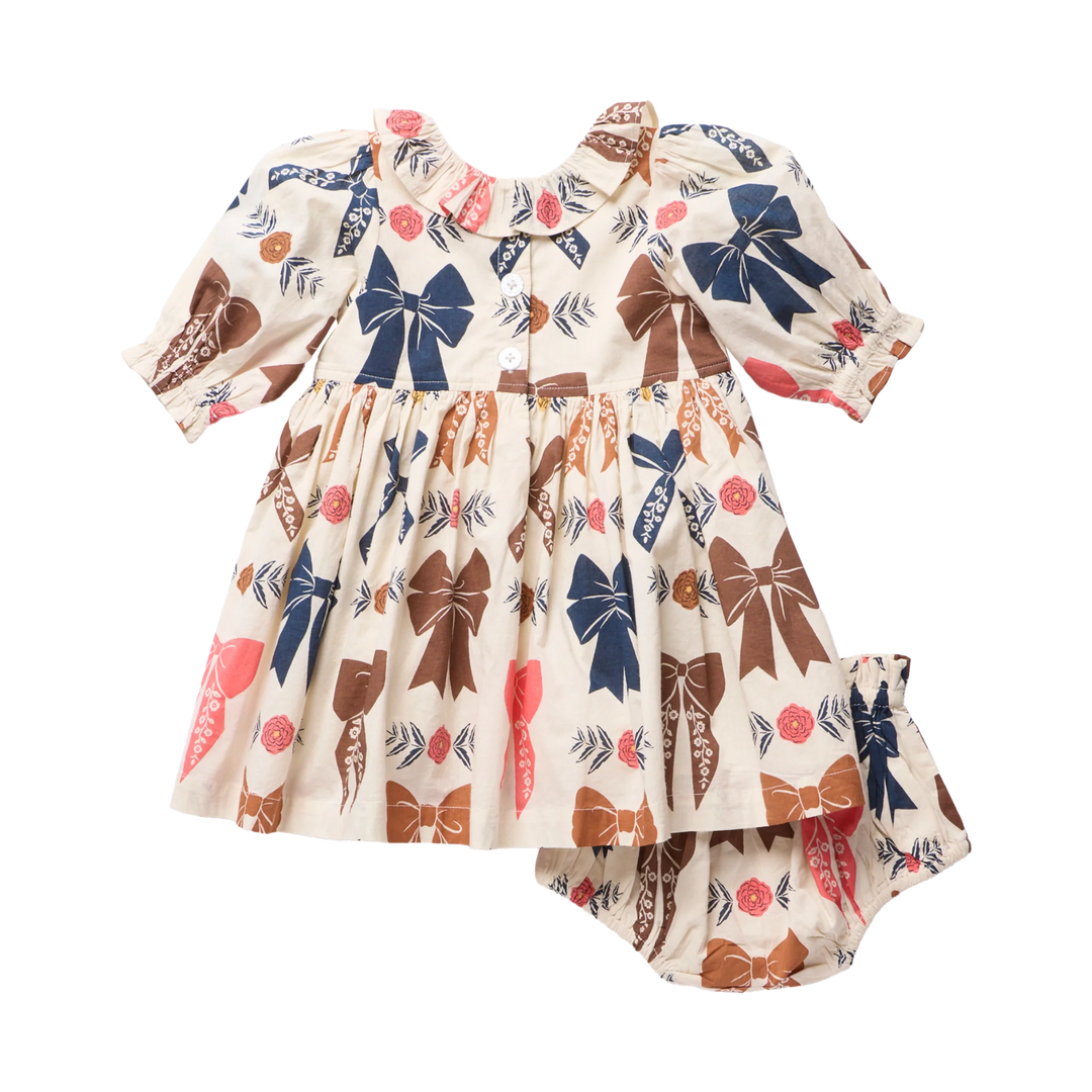 Back view of Baby Girls Harvest Bow Dress Set with button closure and matching printed bloomers