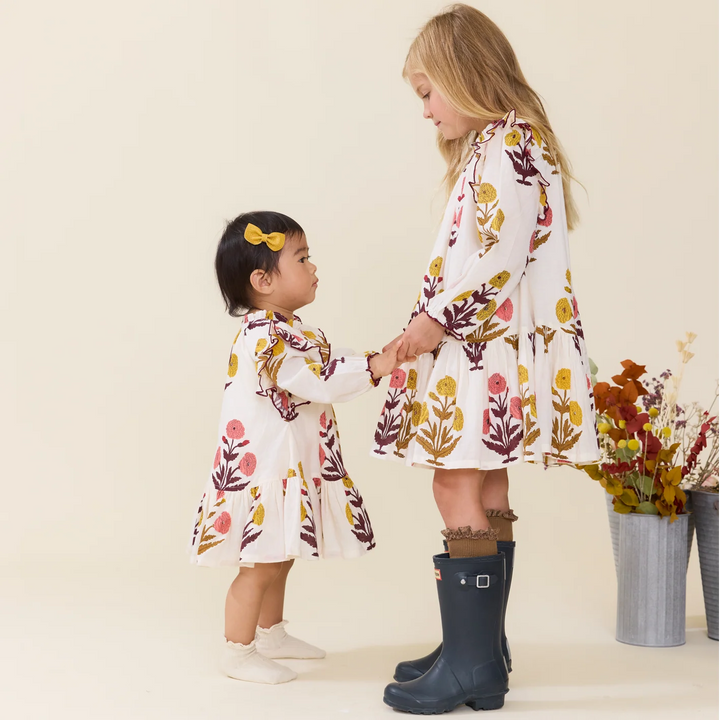 Baby Girls Harvest Dandelion Dress styled with coordinating girls floral dress for matching sister outfits