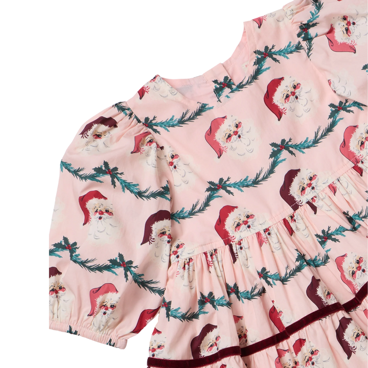Close-up of the Baby Girls Maribelle Dress Set showing vintage Santa faces, evergreen garland, puff sleeves, and burgundy velvet trim.