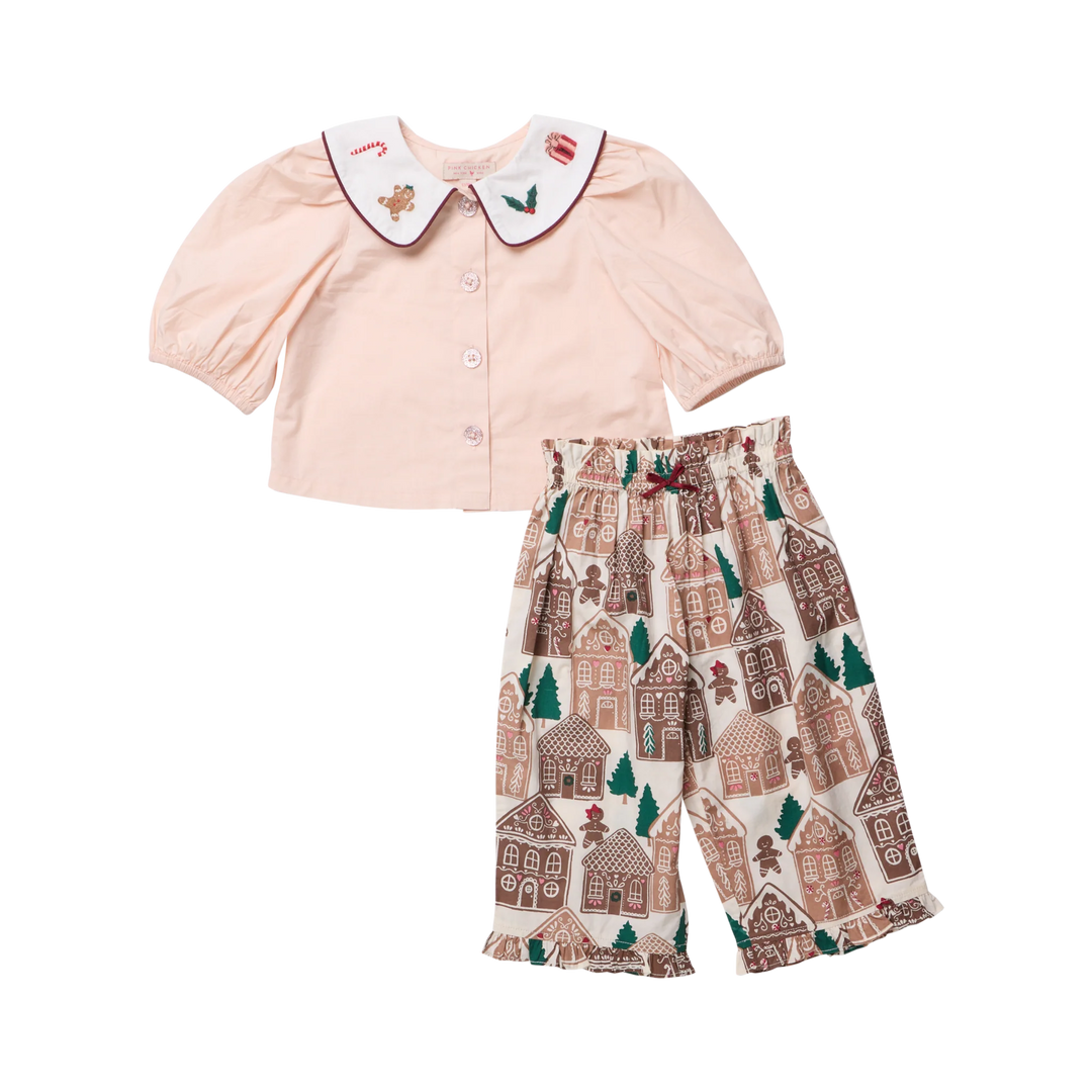 Pink Chicken Baby Girls Noelle 2PC Set featuring a blush pink puff sleeve top with embroidered holiday collar and gingerbread house print pants.