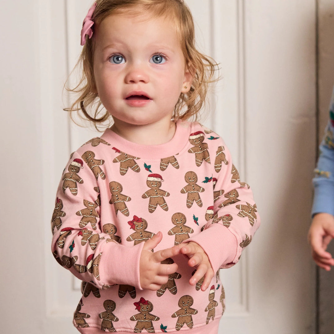 Toddler wearing pink Gingerbread Cookie Baby Jax Jogger Set with festive gingerbread men and ribbed cuffs