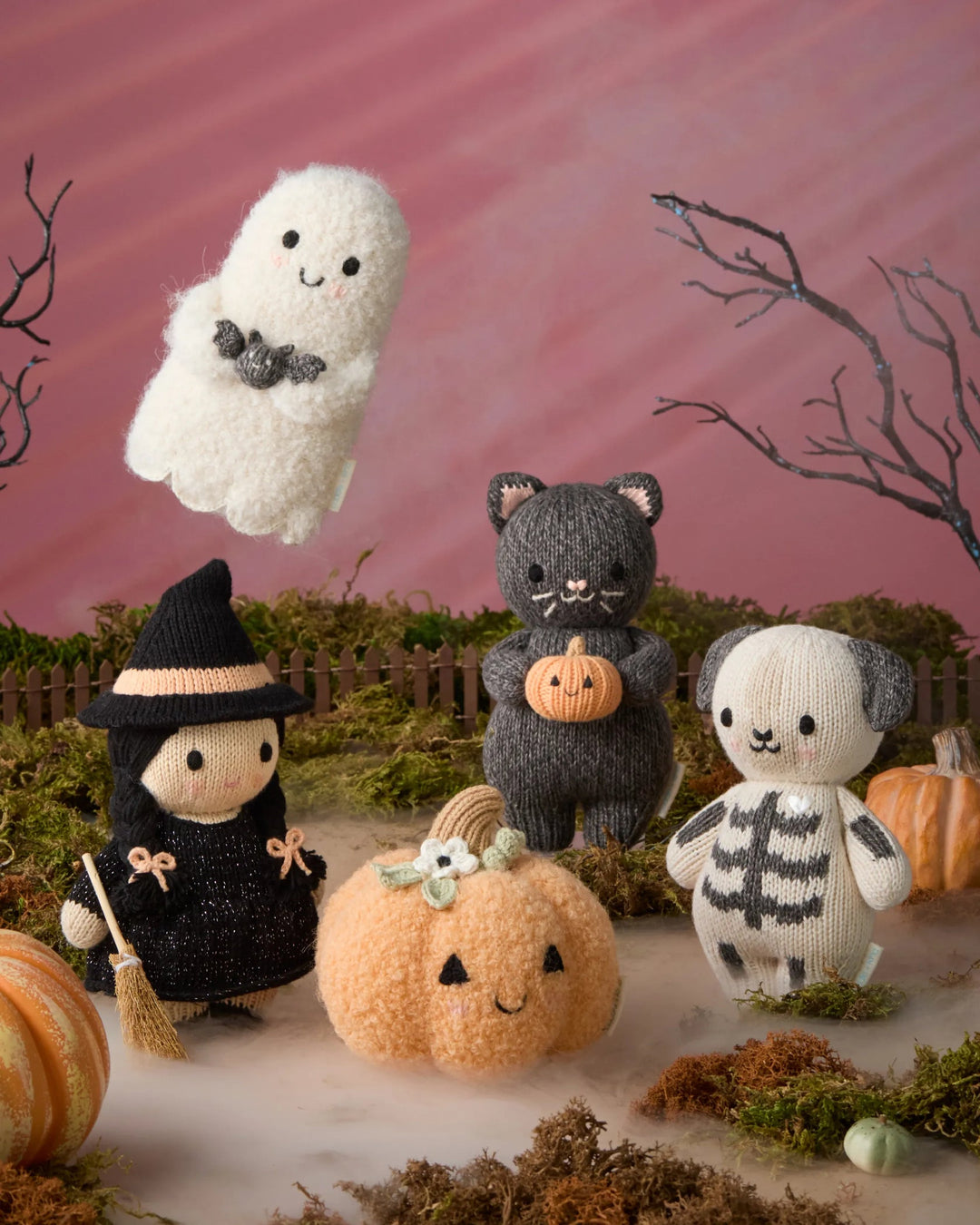 Baby Pumpkin Moonflower plush displayed with witch, black cat, skeleton dog and ghost knit Halloween characters