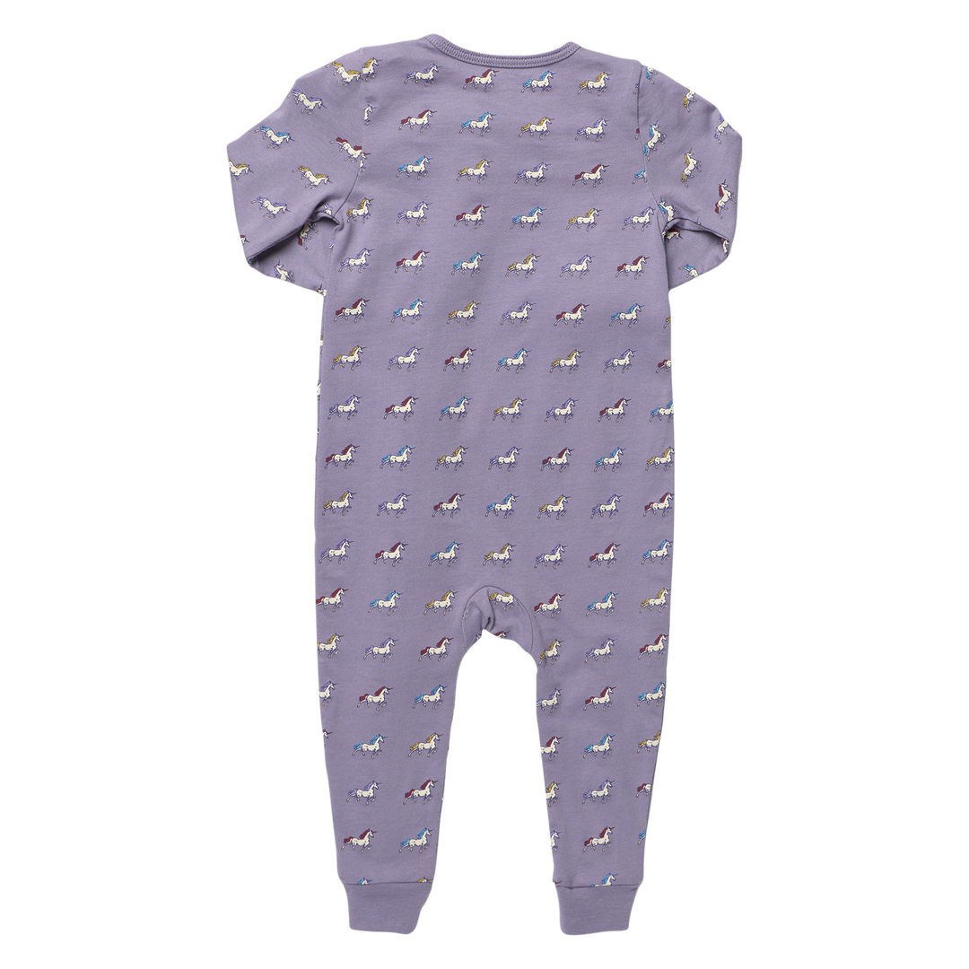 Back view of purple baby unicorn romper featuring a colorful allover unicorn print, long sleeves, and ribbed ankle cuffs.