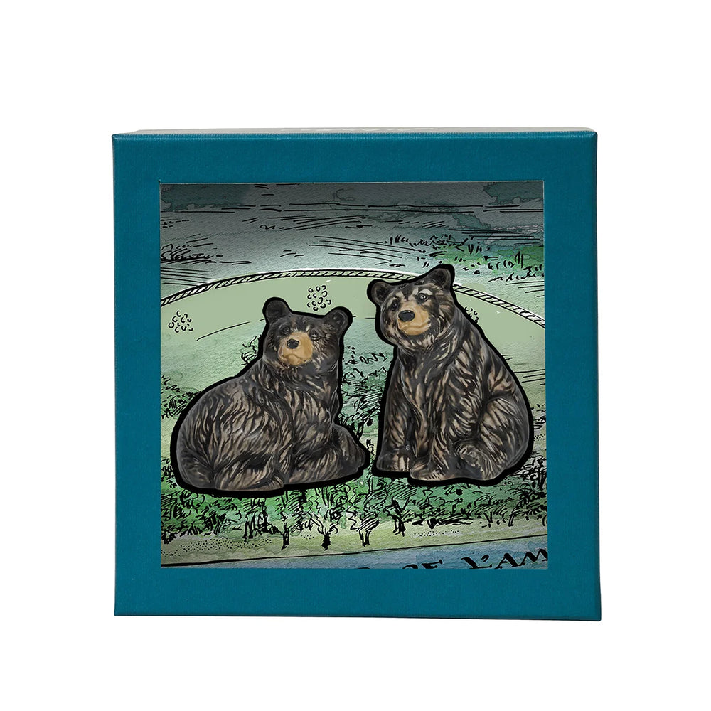 Black bear figurine pair displayed with illustrated woodland packaging, perfect for nature-inspired gifting and home decor.