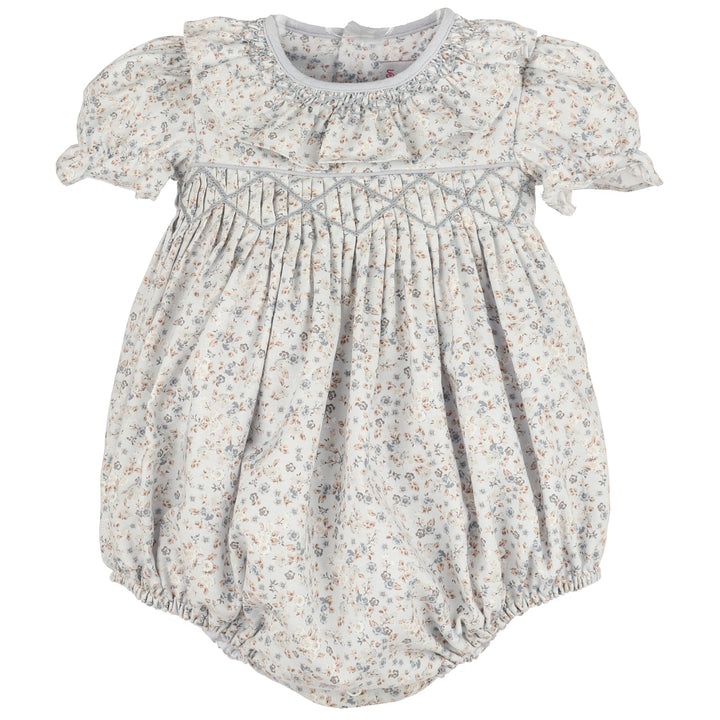 Front view of Bloomy Chintz Blue Smocked Bubble featuring a delicate blue floral print, smocked chest, ruffle collar, puff sleeves, and gathered bubble silhouette.