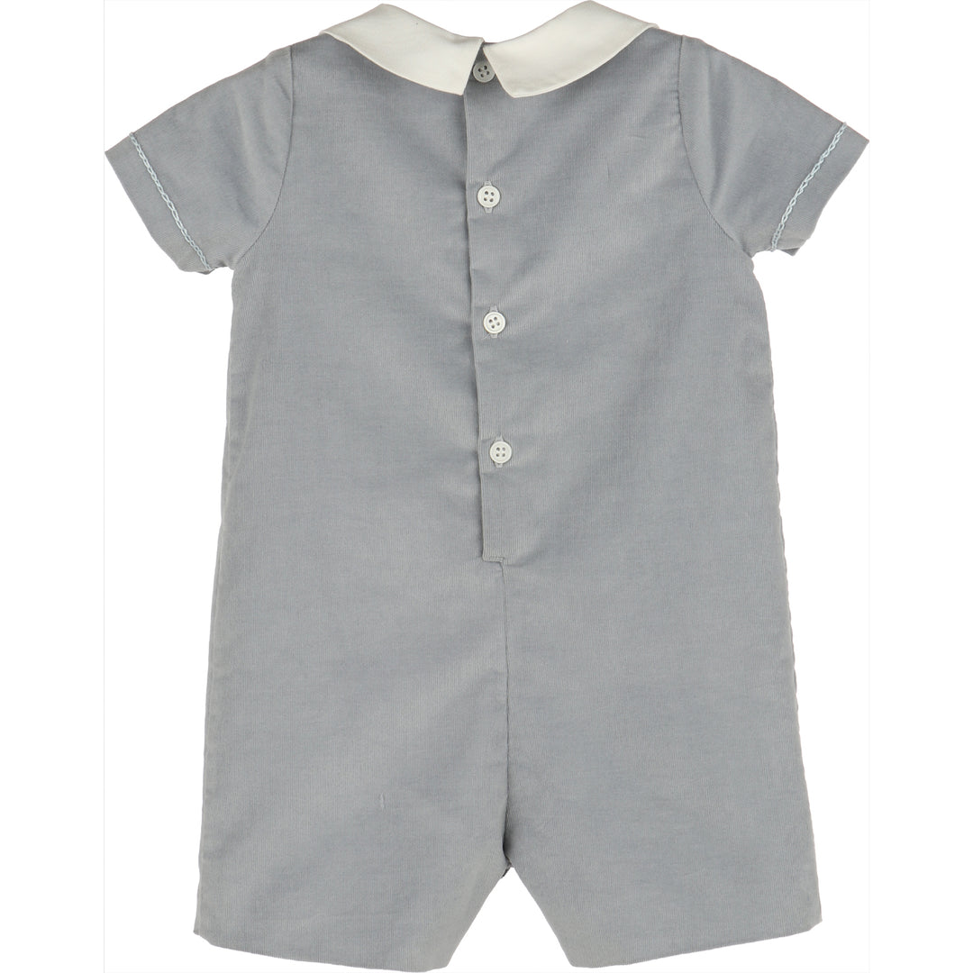 Back view of Blue Minicorduroy Romper for baby boys with white Peter Pan collar, light blue stitching, and button closure