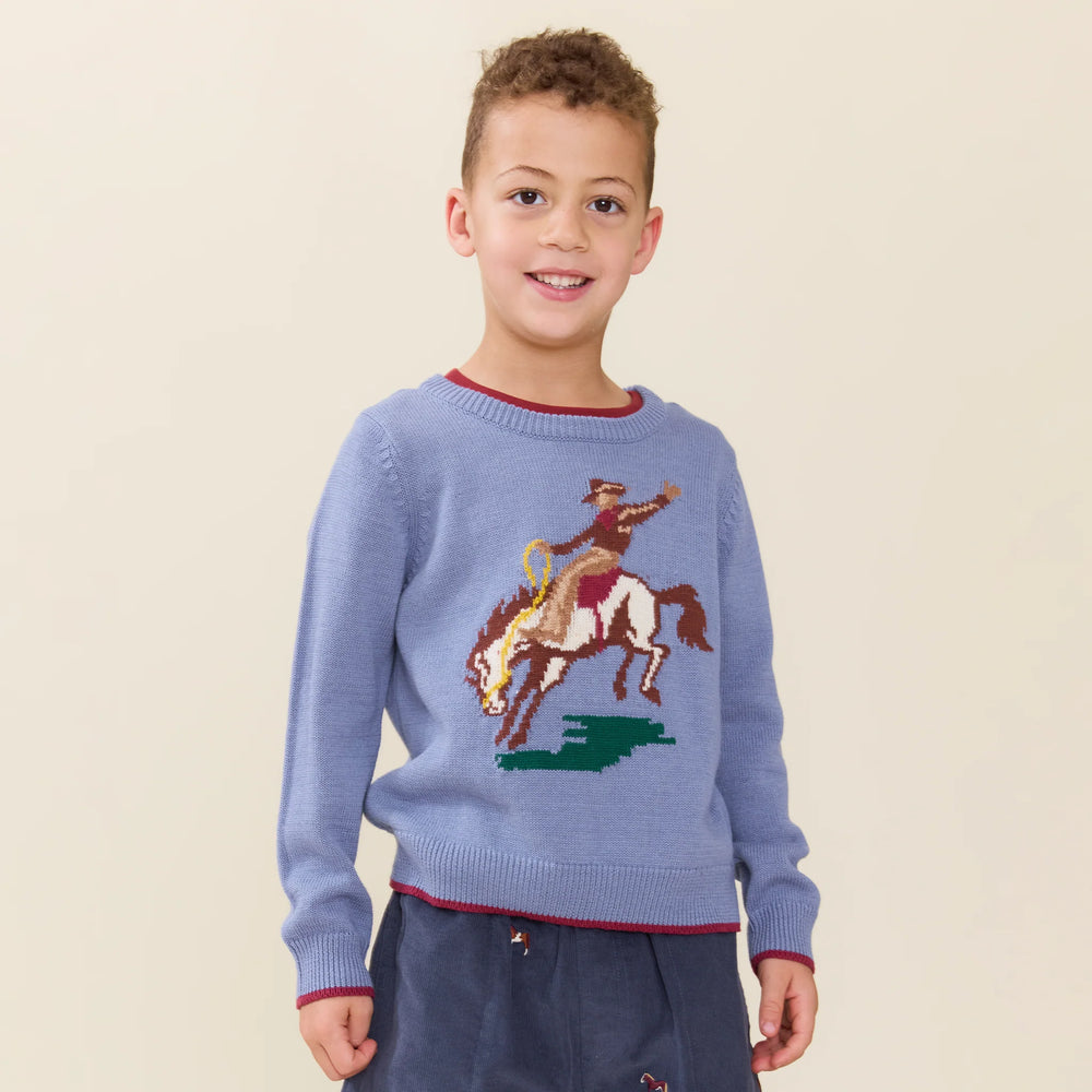 Boy wearing Boys Bronco Sweater in blue with cowboy and bucking horse design
