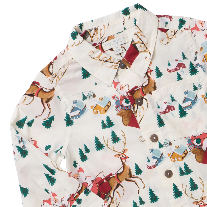 Close-up of Boys Jack Shirt featuring Santa, reindeer, evergreen trees, and snowy cottages