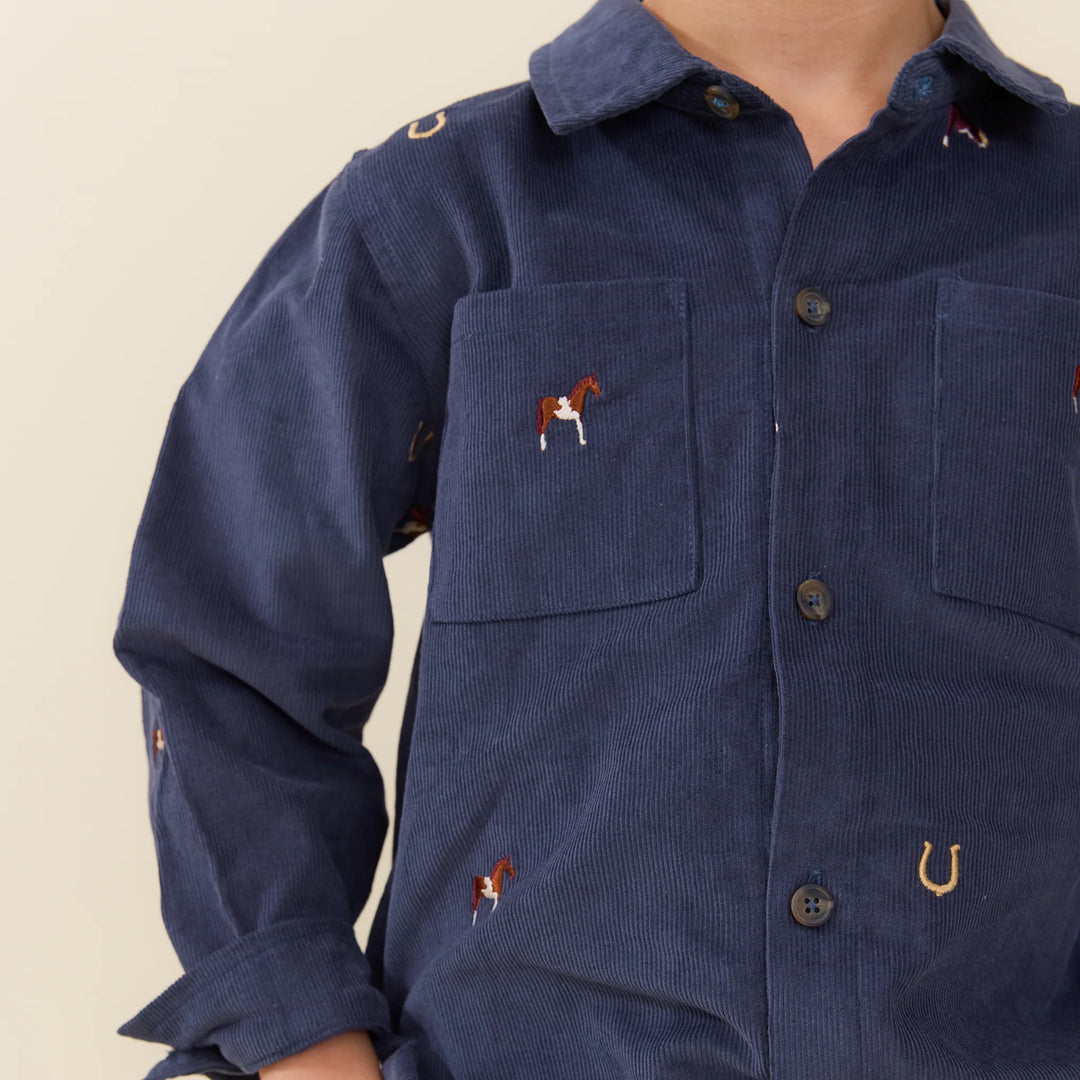 Close-up of Boys Navy Horse Embroidered Shirt featuring horse and horseshoe embroidery and chest pockets