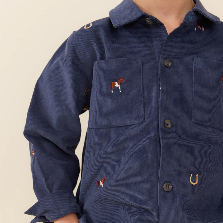 Close-up of Boys Navy Horse Embroidered Shirt featuring horse and horseshoe embroidery and chest pockets