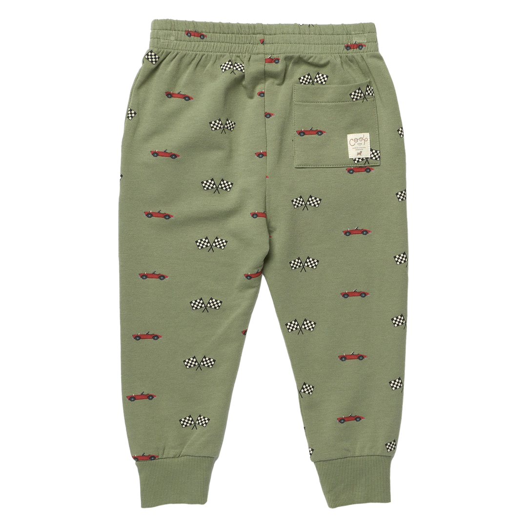 Back view of boys olive green race car jogger pants with red cars, checkered flags, cuffed ankles and back patch pocket