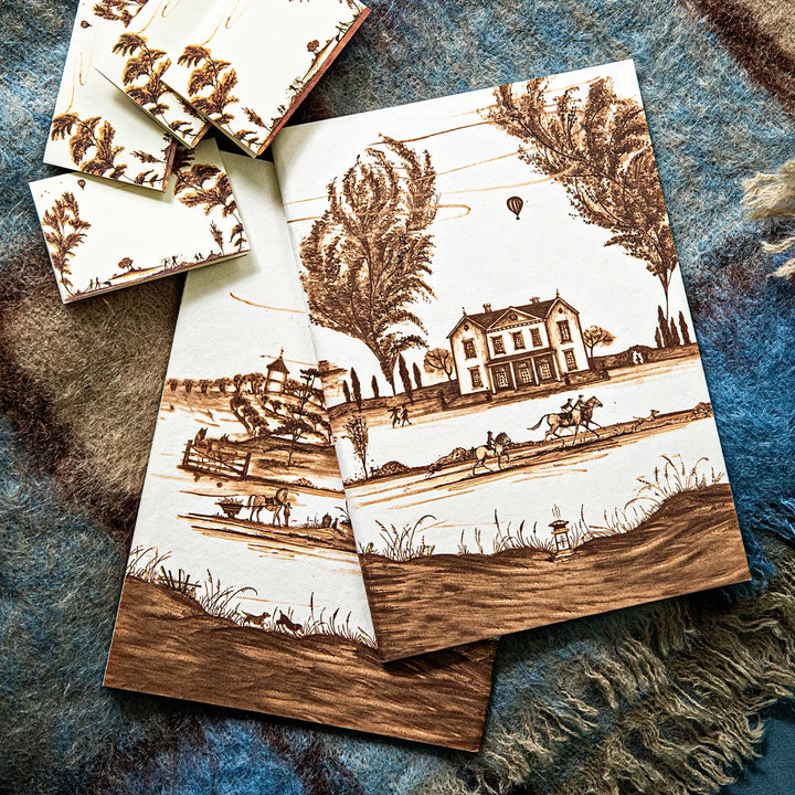 Brown countryside toile journals styled together featuring coordinating estate, equestrian and pastoral scenes