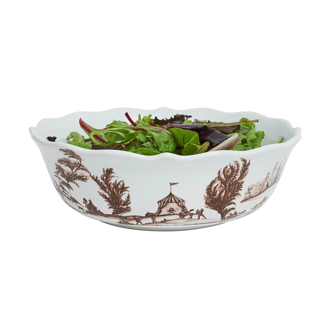 Brown toile serving bowl filled with fresh salad, featuring a scalloped rim and brown pastoral artwork