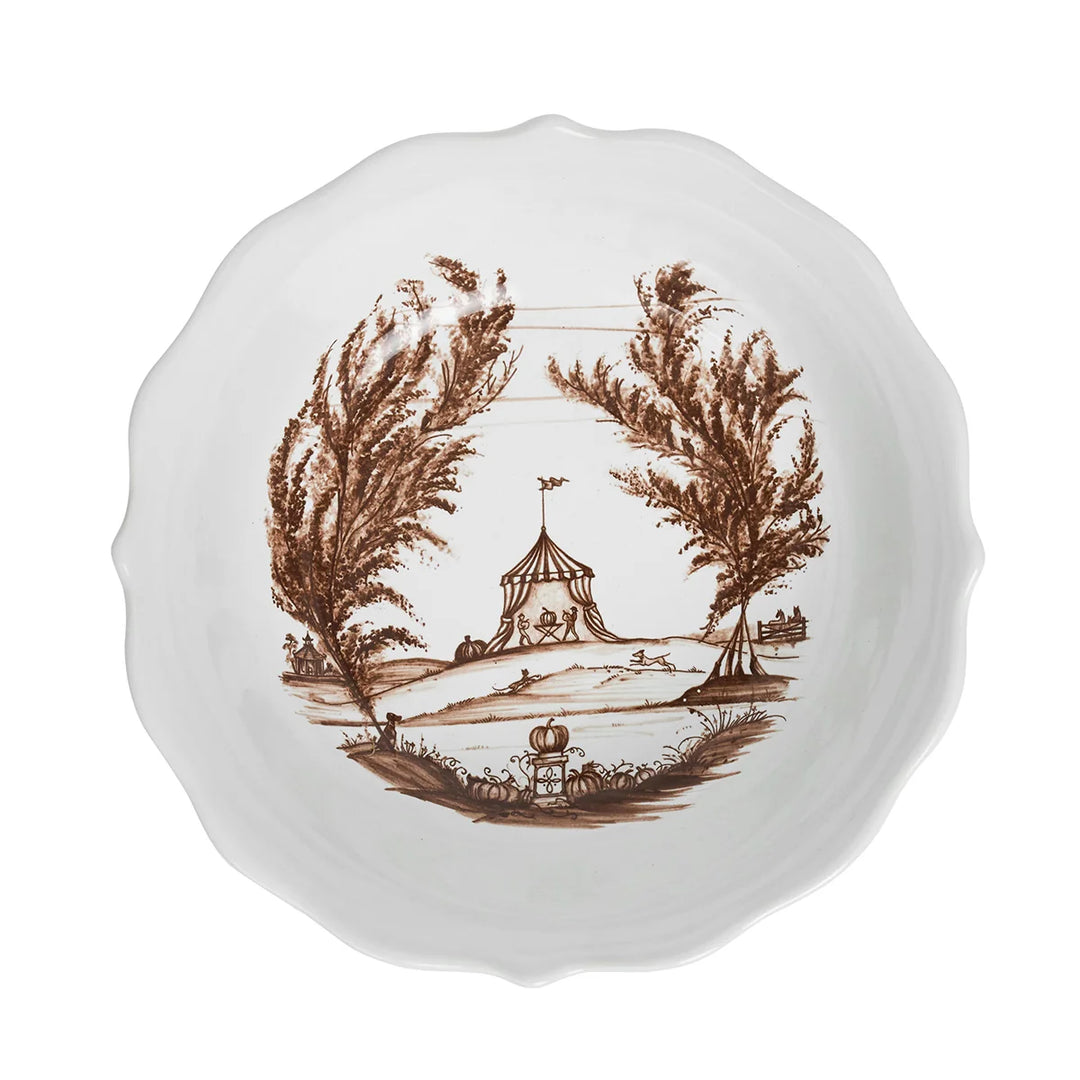 Top view of brown toile serving bowl with scalloped edge and detailed pastoral landscape illustration inside