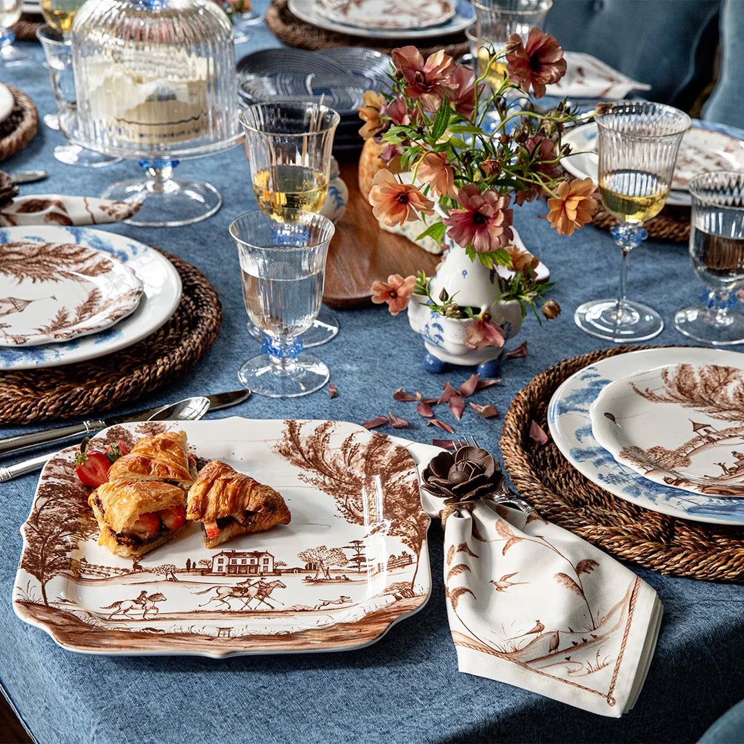Brown toile square serving platter with pastries styled on an elegant dining table with coordinating toile tableware