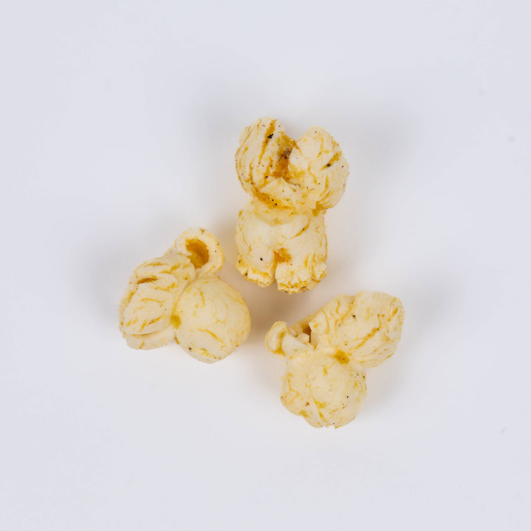 Close-up of buttery Caramelized Onion + Sage popcorn seasoned with savory herbs