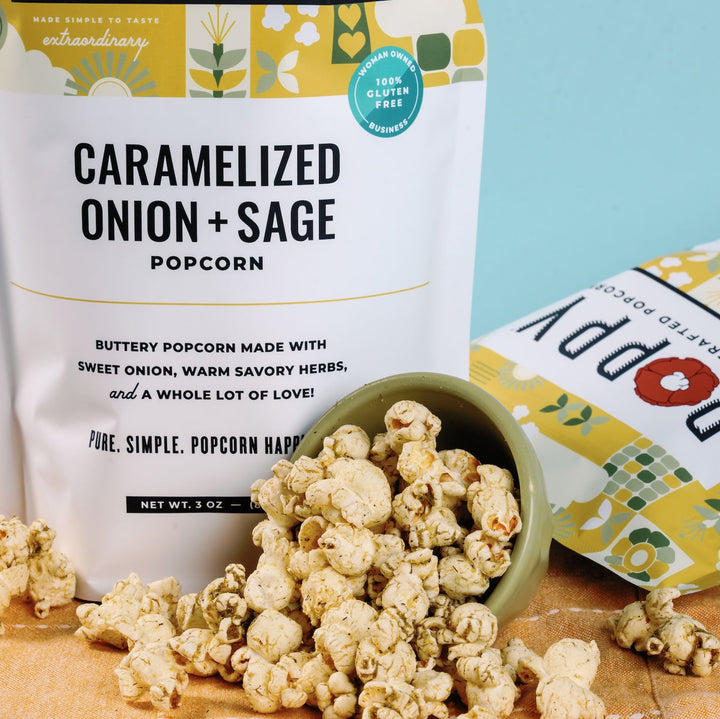 Close-up of Poppy Caramelized Onion + Sage popcorn bag with seasoned popcorn