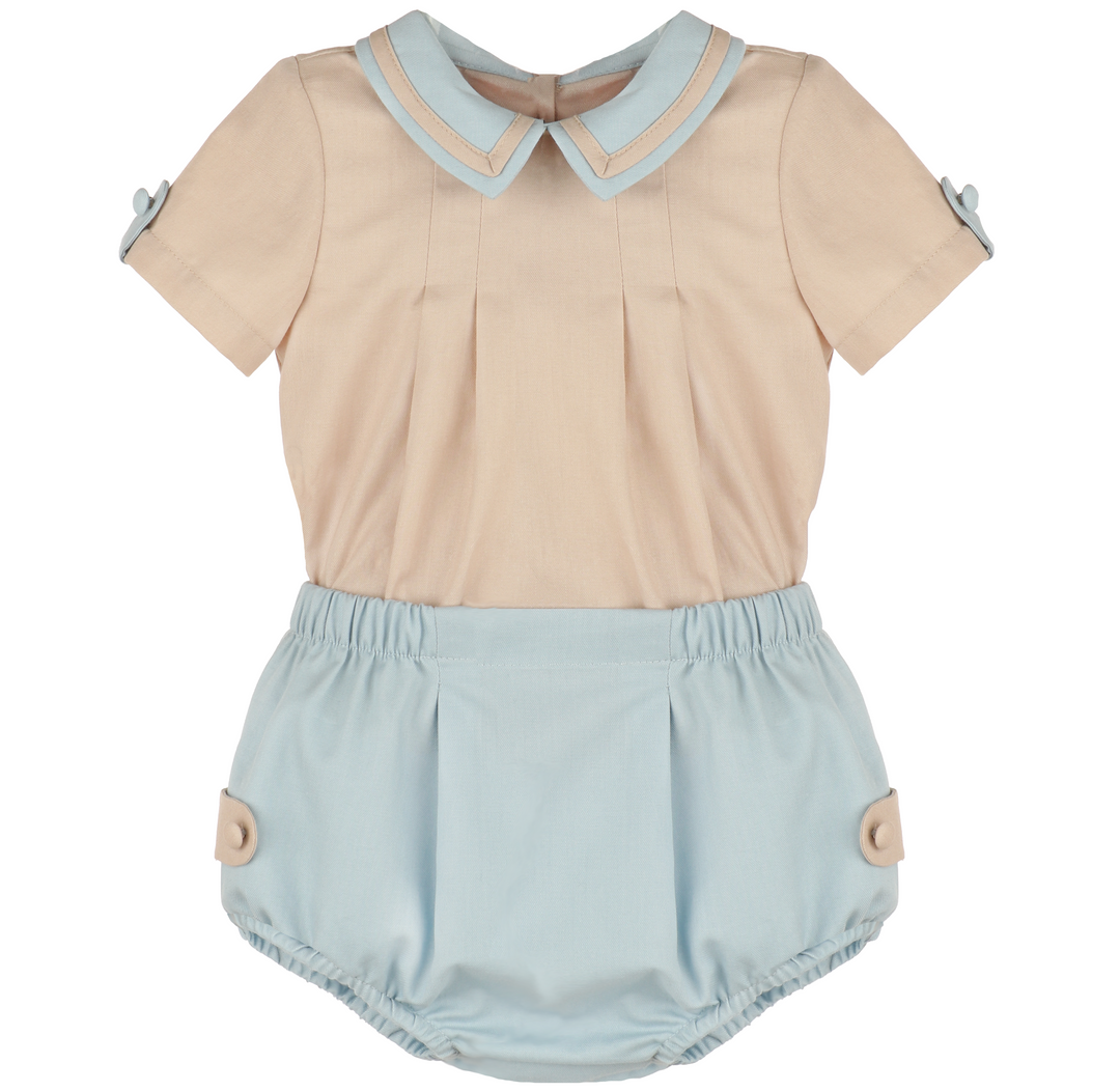 Front view of Chambray &amp; Oatmeal baby boy set with oatmeal short-sleeve top, chambray Peter Pan collar, pleated front, and blue bloomers.