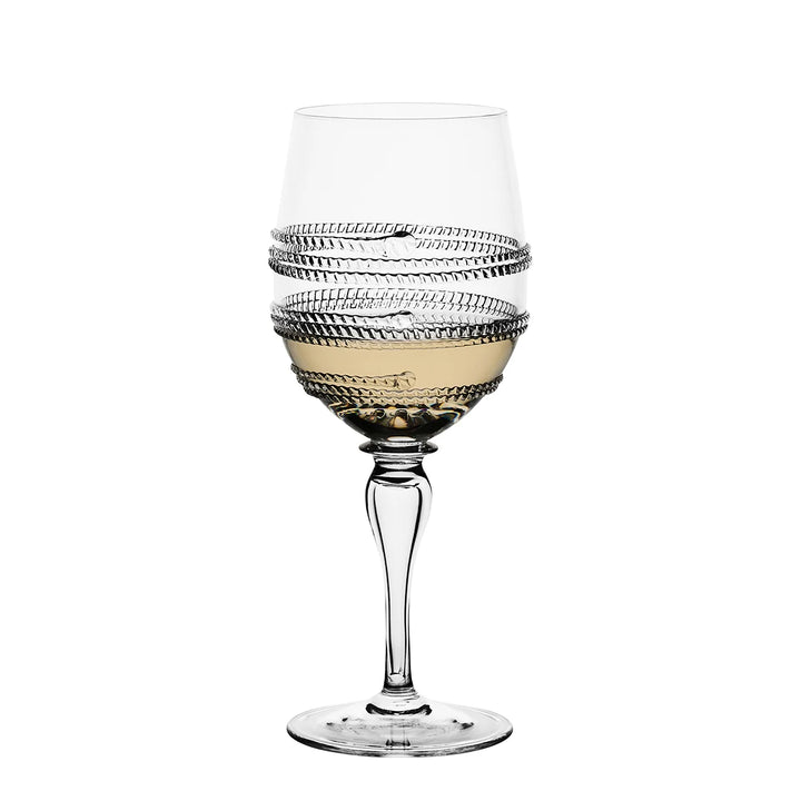 Clear stemmed wine glass with white wine and decorative textured glass wrap detailing