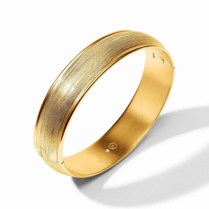 Angled view of gold Cobblestone Hinge Bangle showing textured finish and hinge