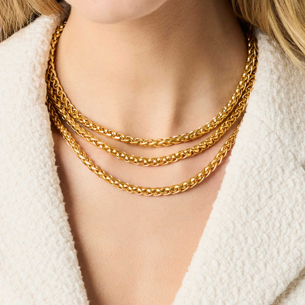 Gold Cobblestone Link Necklace layered with coordinating gold chains on model