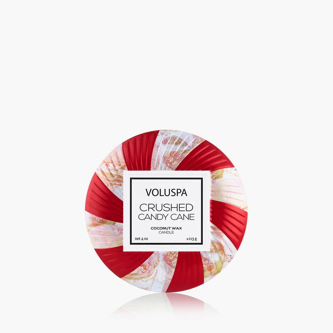 Voluspa Crushed Candy Cane Mini Tin Candle with festive red and white peppermint swirl design