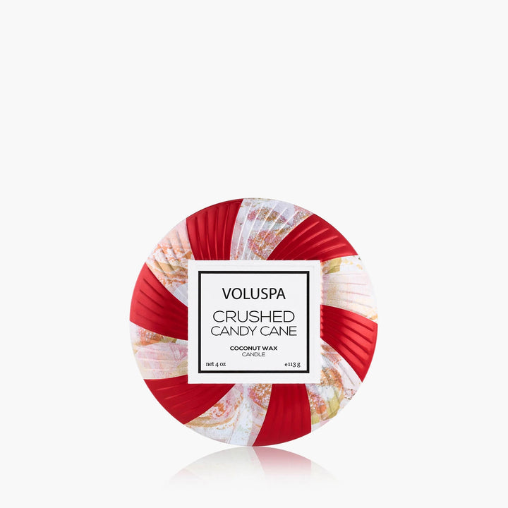 Voluspa Crushed Candy Cane Mini Tin Candle with festive red and white peppermint swirl design