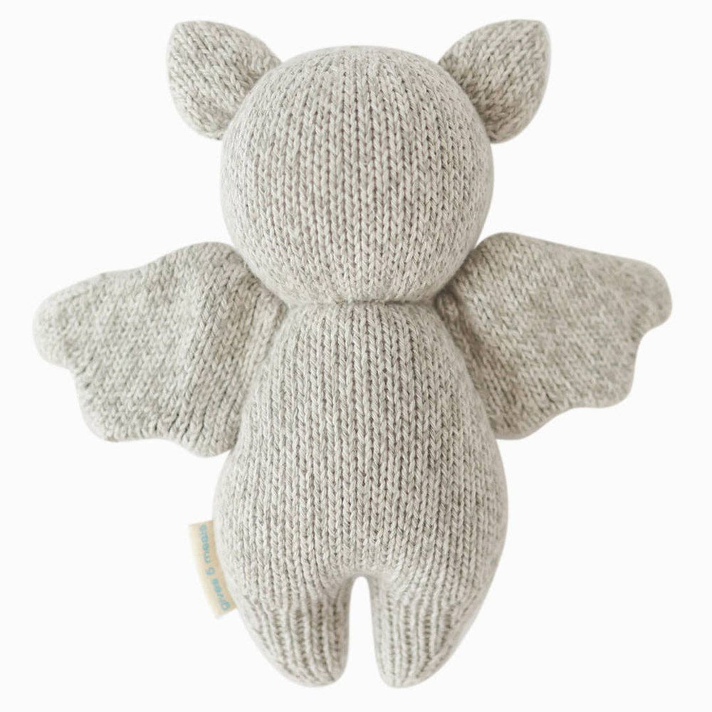 Flat image of the back of Cuddle+Kind's light grey plush Baby Bat on a clean white background