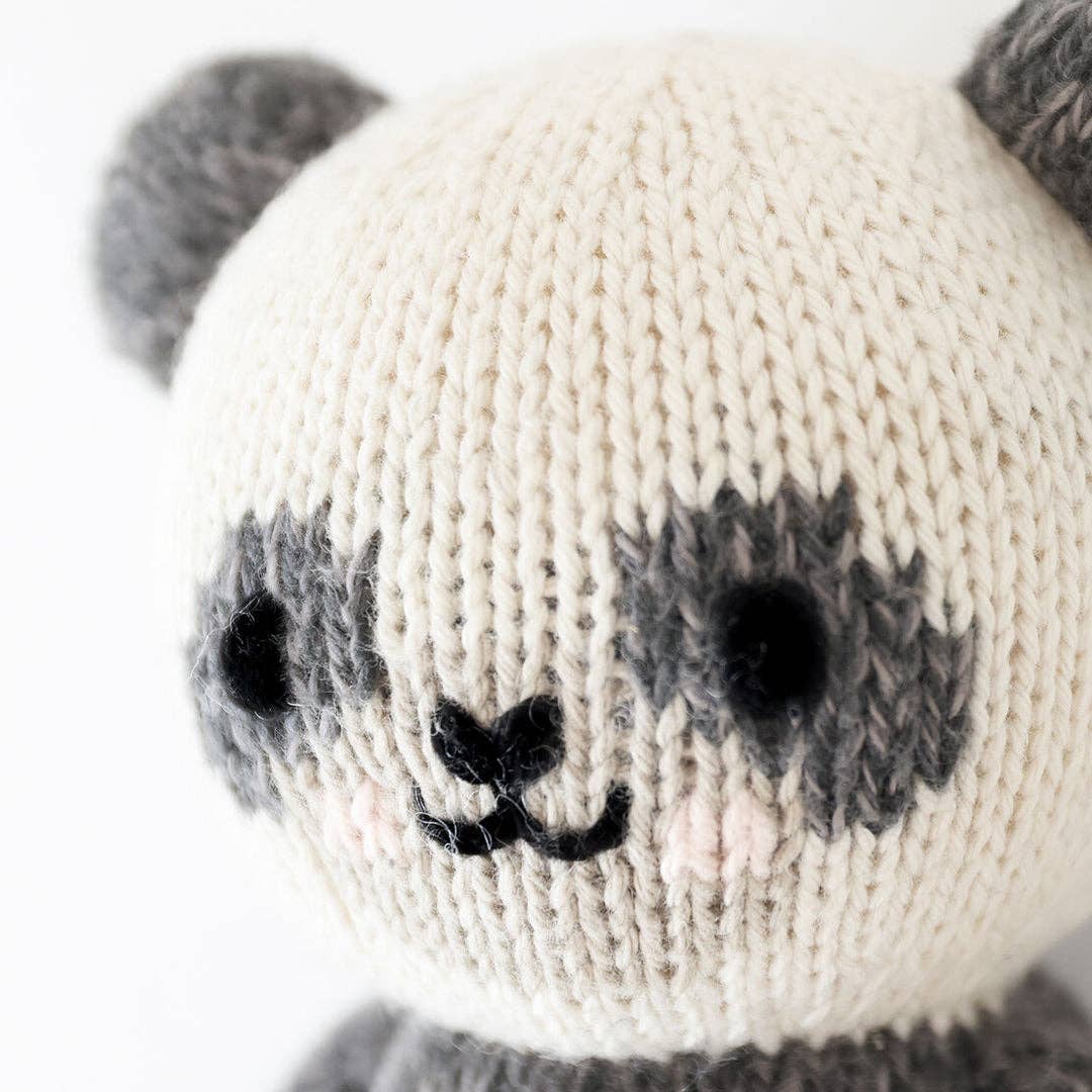 Cuddle+Kind Baby Panda plush close-up, gray ears and eye patches, black nose, and smiling face