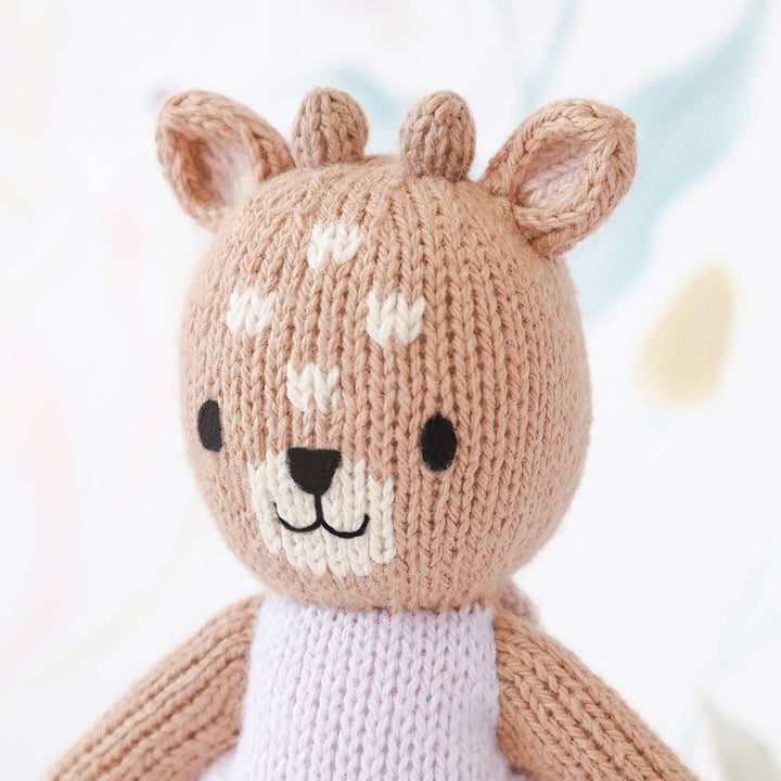 Close up image of the face of Cuddle+Kind&