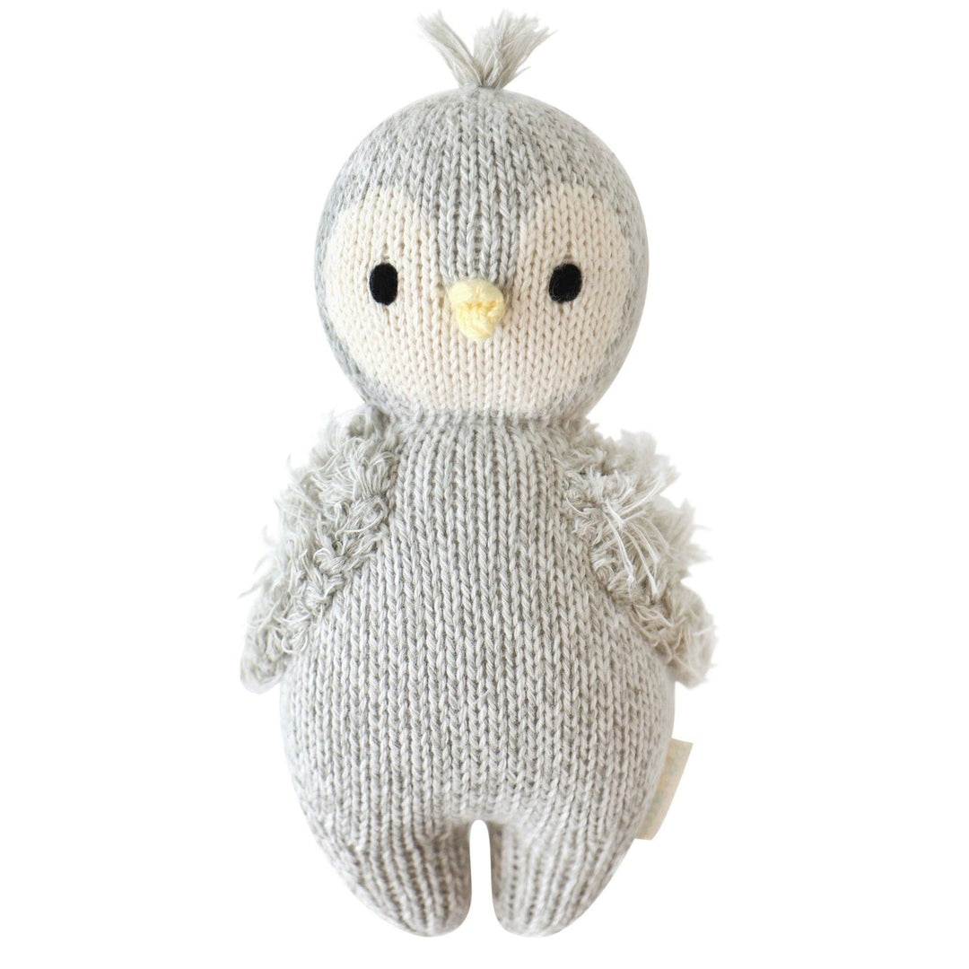 Flat image of the front of Cuddle+Kind's light gray plush Baby Penguin on a clean white background