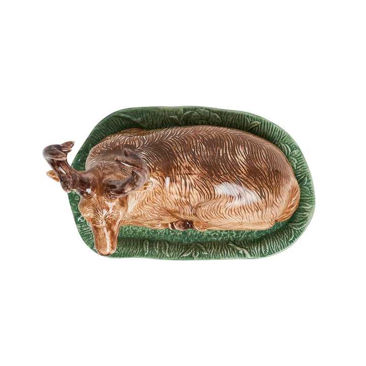 Top view of ceramic stag butter dish showing the detailed brown deer cover resting on a rectangular green woodland tray.