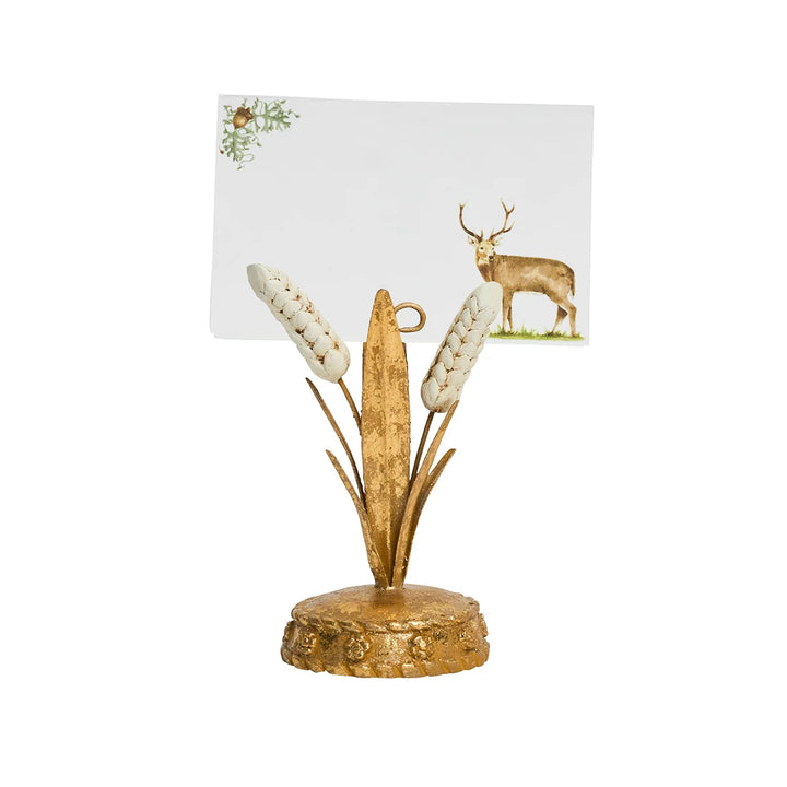 Deer Christmas place card displayed in a gold botanical card holder for an elegant holiday table setting.