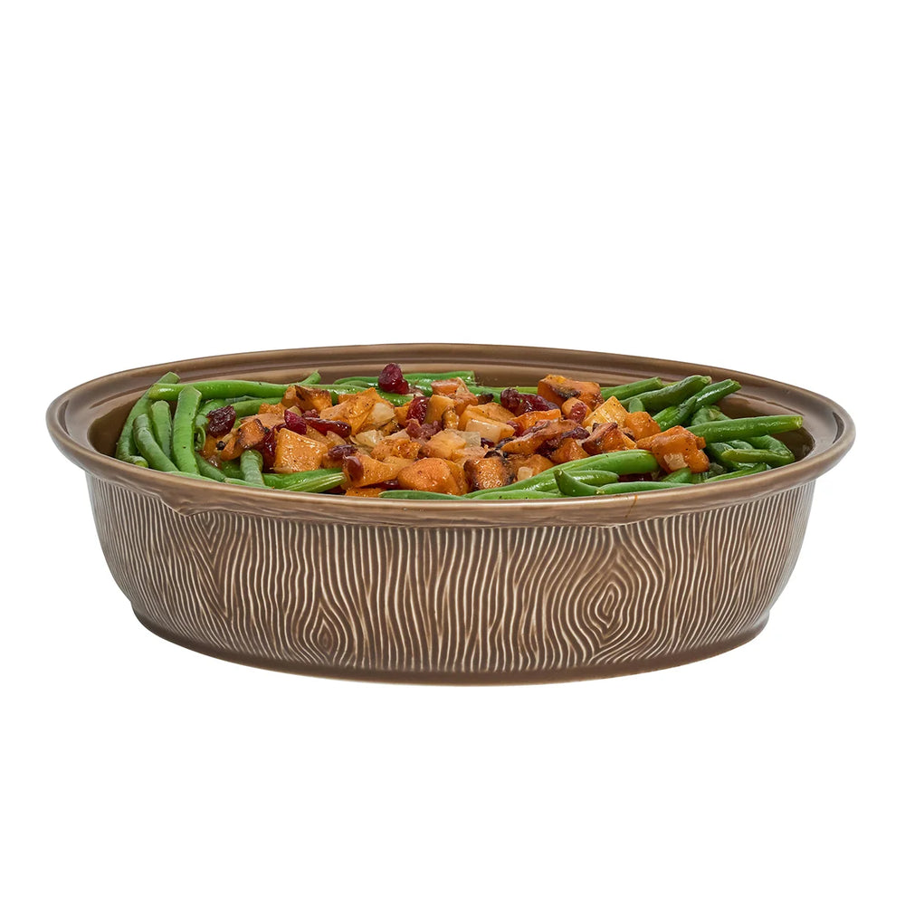 Oval brown ceramic deer serving bowl filled with green beans and roasted vegetables, showing the dish without its decorative lid.