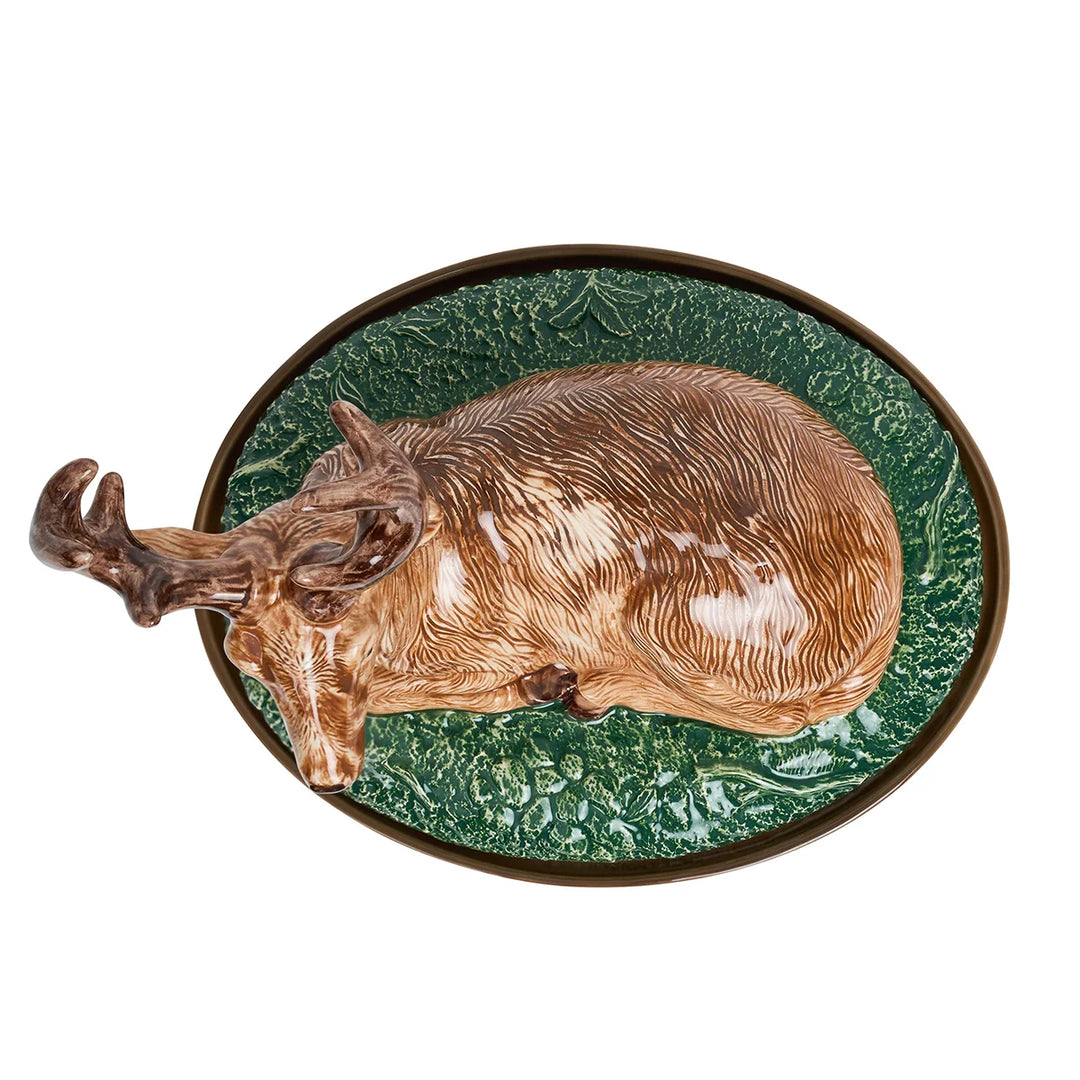 Top view of ceramic deer covered serving dish with detailed resting stag, brown antlers and textured green woodland lid.