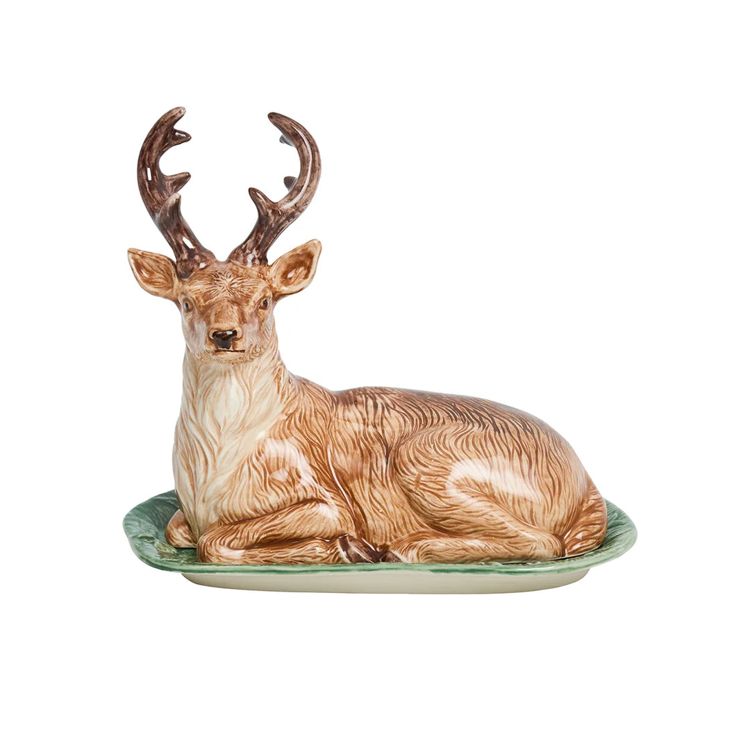 Front view of a woodland deer butter dish with sculpted resting stag cover and green ceramic base.