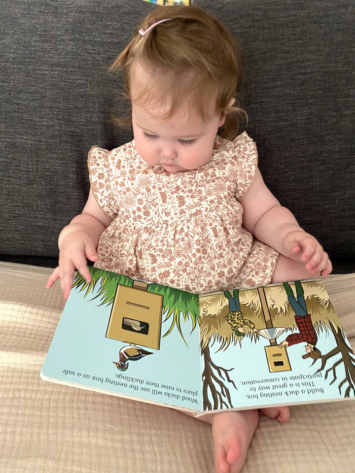 Toddler reading the Duck Hunt children&