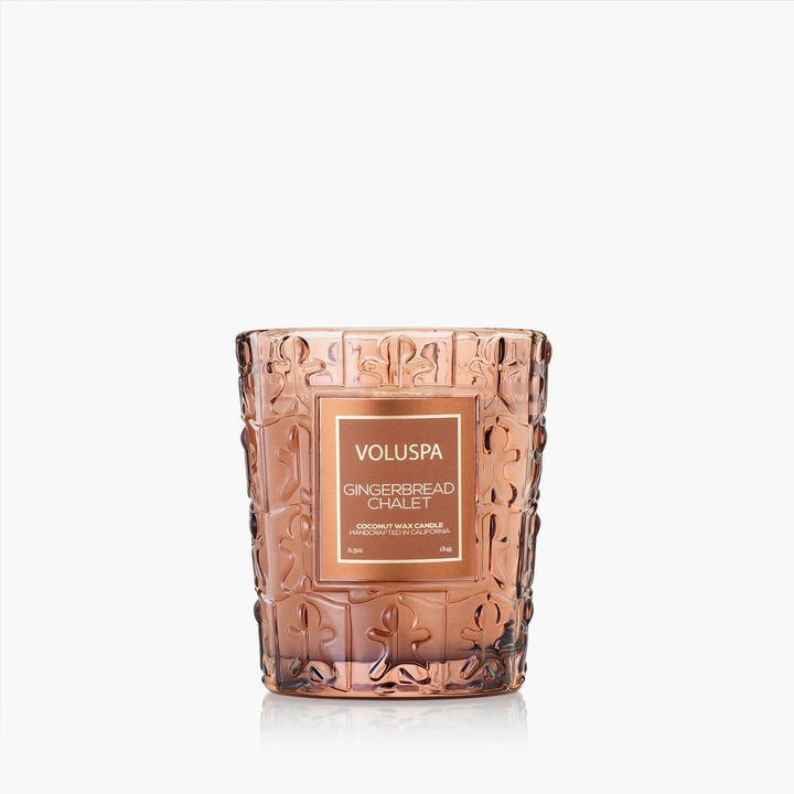 Voluspa Gingerbread Chalet Classic Candle in warm amber embossed glass vessel