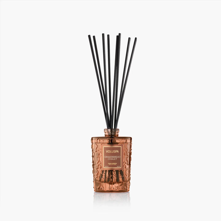 Gingerbread Chalet Reed Diffuser by Voluspa in embossed amber glass with black diffuser reeds