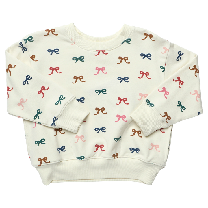 Cream girls sweatshirt featuring an all-over multicolor bow print with long sleeves and ribbed cuffs, neckline and hem